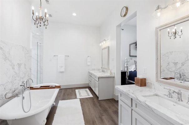 Bathroom, Chandelier, Dual Sink Vanities, Free Standing Baths, Interior, Marble Walls, Recessed Lighting, Wood Texture Flooring