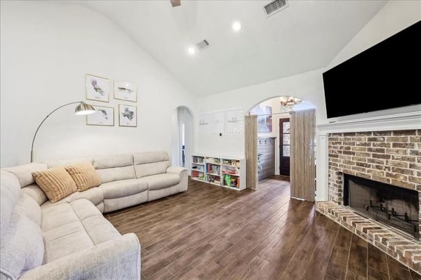 Chandelier, Fireplace, Interior, Living room, Recessed Lighting, Stone Walls, Wood Texture Flooring