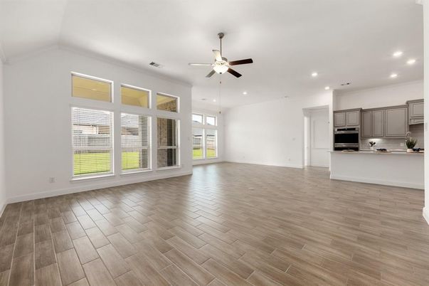 Empty room, Interior, Kitchen, Recessed Lighting, Stainless Steel Appliances, Wood Texture Flooring