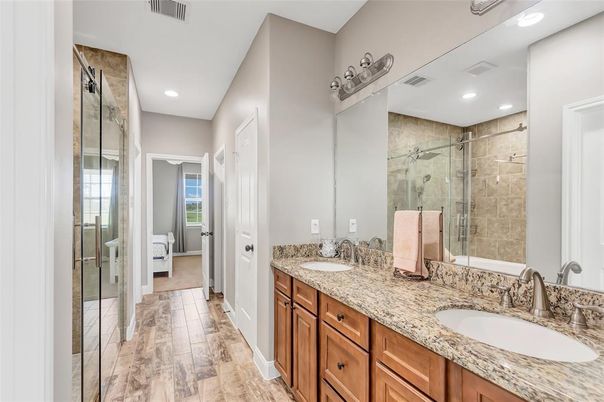 Bathroom, Dual Sink Vanities, Glass Shower, Interior, Recessed Lighting, Wood Texture Flooring
