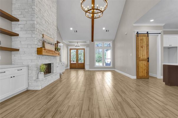 Chandelier, Empty room, Fireplace, Interior, Recessed Lighting, Stone Walls, Wooden Beams, Wood Texture Flooring