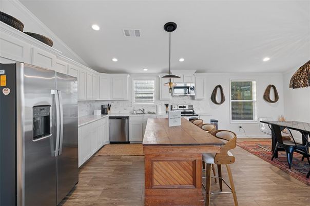 Dining room, Interior, Kitchen, Pendant Lights, Recessed Lighting, Stainless Steel Appliances, Wood Texture Flooring