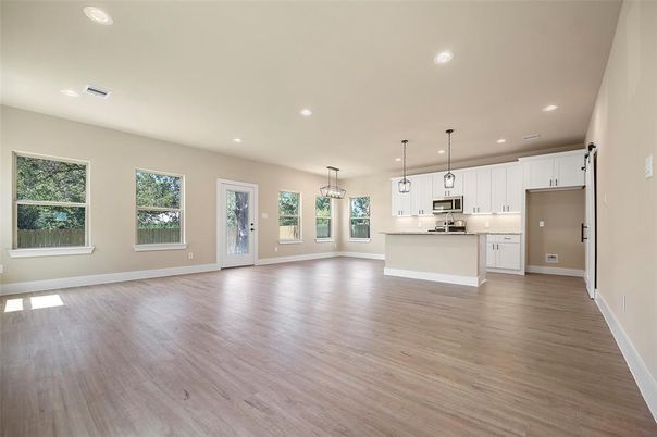 Empty room, Interior, Kitchen, Pendant Lights, Recessed Lighting, Stainless Steel Appliances, Wood Texture Flooring