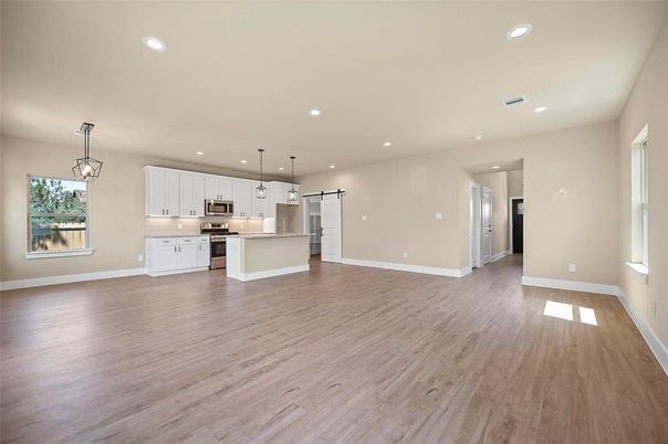 Empty room, Interior, Kitchen, Pendant Lights, Recessed Lighting, Stainless Steel Appliances, Wood Texture Flooring