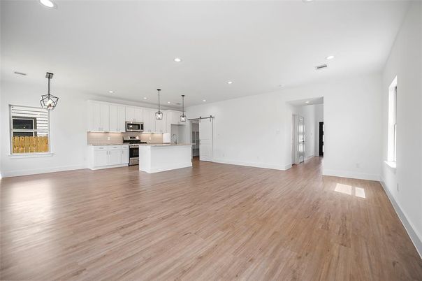 Empty room, Interior, Kitchen, Pendant Lights, Recessed Lighting, Stainless Steel Appliances, Wood Texture Flooring