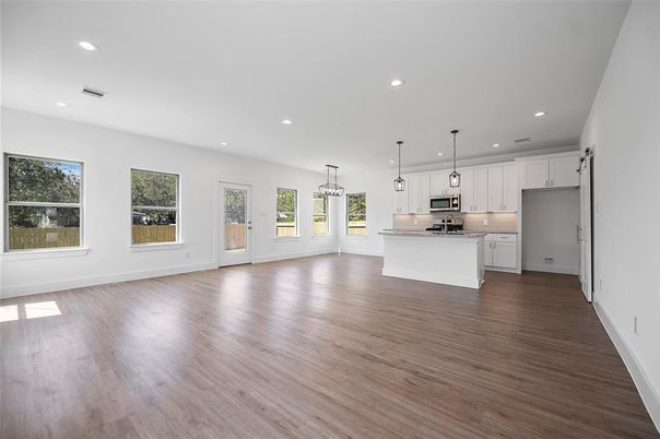 Empty room, Interior, Kitchen, Pendant Lights, Recessed Lighting, Stainless Steel Appliances, Wood Texture Flooring