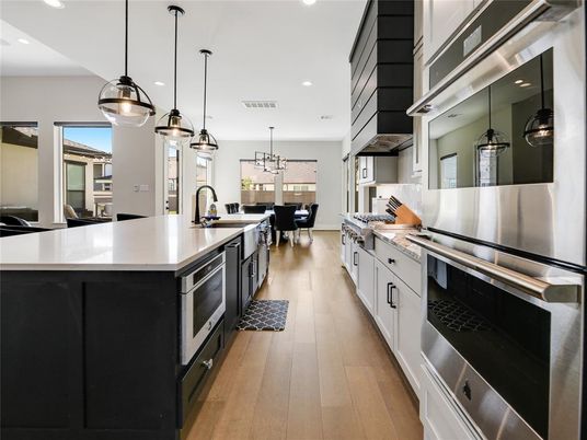 Chandelier, Dining room, Interior, Kitchen, Pendant Lights, Recessed Lighting, Stainless Steel Appliances, Wood Texture Flooring