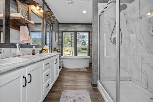 Bathroom, Dual Sink Vanities, Free Standing Baths, Glass Shower, Interior, Marble Walls, Recessed Lighting, Wood Texture Flooring