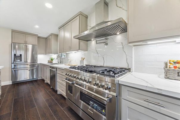 Interior, Kitchen, Marble Walls, Recessed Lighting, Stainless Steel Appliances, Wood Texture Flooring