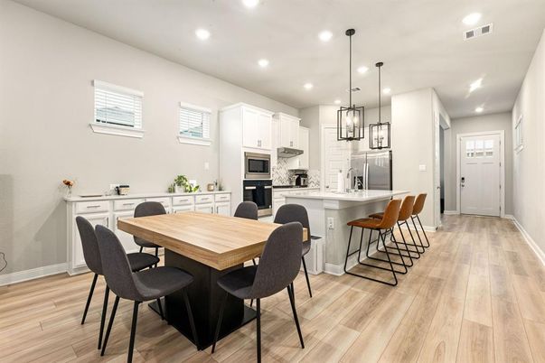 Dining room, Interior, Kitchen, Pendant Lights, Recessed Lighting, Stainless Steel Appliances, Wood Texture Flooring