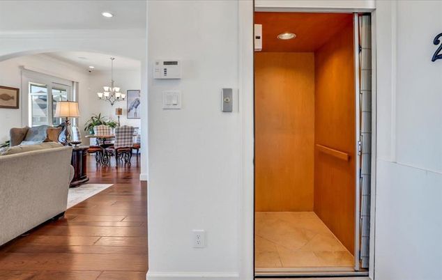 Chandelier, Dining room, Elevator, Interior, Living room, Recessed Lighting, Wood Texture Flooring, Wooden Walls