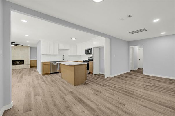 Fireplace, Interior, Kitchen, Recessed Lighting, Stainless Steel Appliances, Wood Texture Flooring