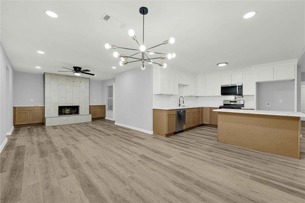 Fireplace, Interior, Kitchen, Pendant Lights, Recessed Lighting, Stainless Steel Appliances, Wood Texture Flooring