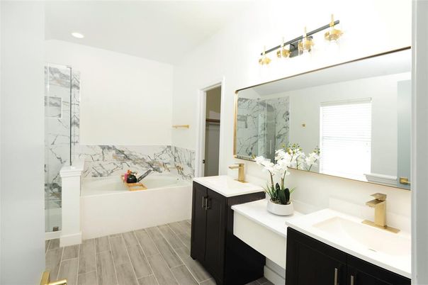 Bathroom, Dual Sink Vanities, Interior, Marble Walls, Recessed Lighting, Wood Texture Flooring