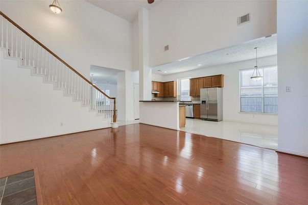 Empty room, Interior, Kitchen, Pendant Lights, Stainless Steel Appliances, Wood Texture Flooring