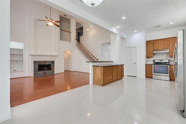 Fireplace, Interior, Kitchen, Recessed Lighting, Stainless Steel Appliances, Wood Texture Flooring