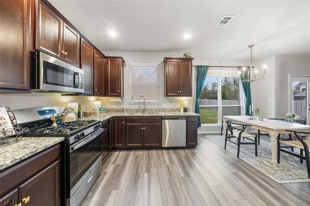 Chandelier, Dining room, Interior, Kitchen, Recessed Lighting, Stainless Steel Appliances, Wood Texture Flooring