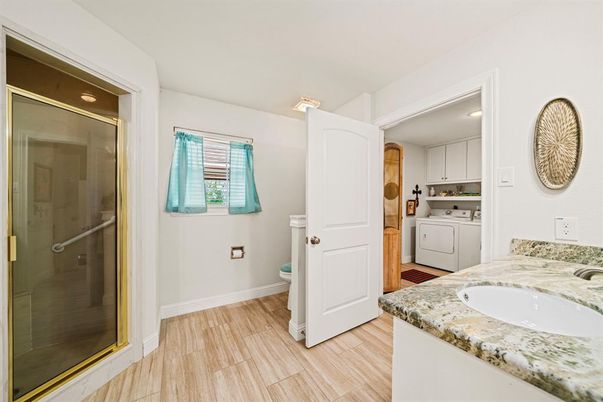 Bathroom, Interior, Recessed Lighting, Washer, Wood Texture Flooring
