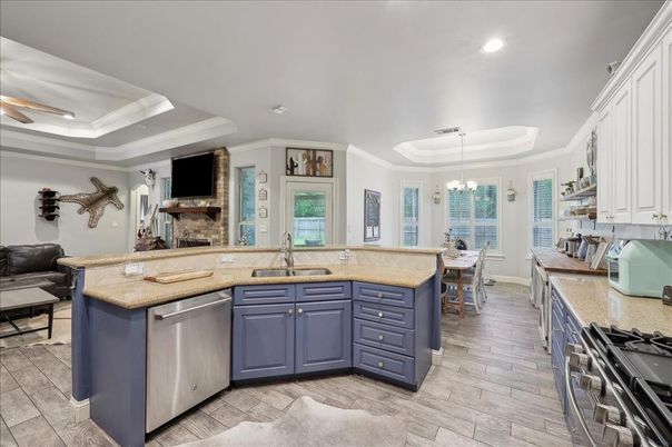 Chandelier, Dining room, Fireplace, Interior, Kitchen, Pendant Lights, Recessed Lighting, Stainless Steel Appliances, Wood Texture Flooring
