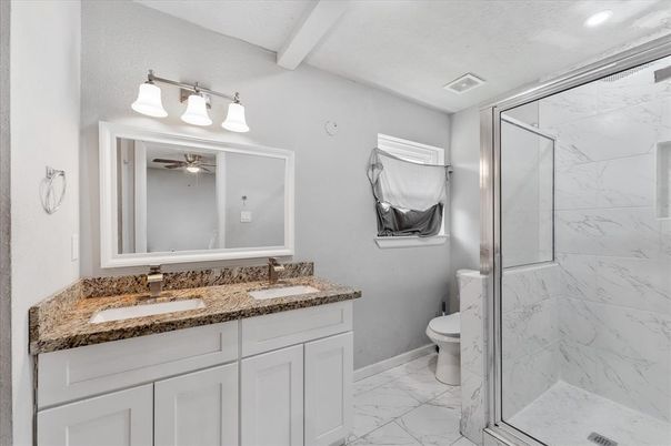 Bathroom, Dual Sink Vanities, Glass Shower, Interior, Marble, Marble Walls, Recessed Lighting