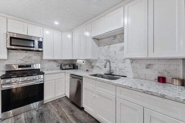 Interior, Kitchen, Marble Walls, Recessed Lighting, Stainless Steel Appliances, Wood Texture Flooring