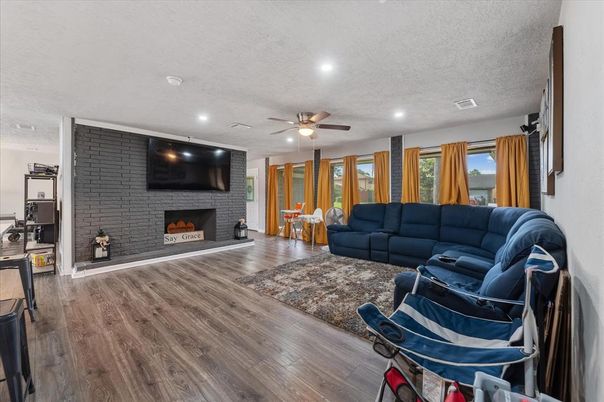 Fireplace, Interior, Living room, Recessed Lighting, Stone Walls, Wood Texture Flooring
