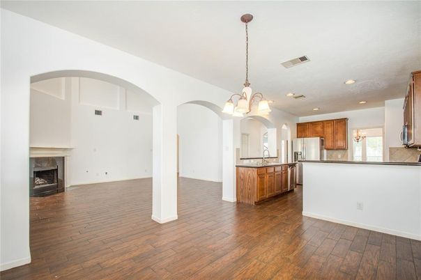 Chandelier, Empty room, Fireplace, Interior, Kitchen, Recessed Lighting, Wood Texture Flooring