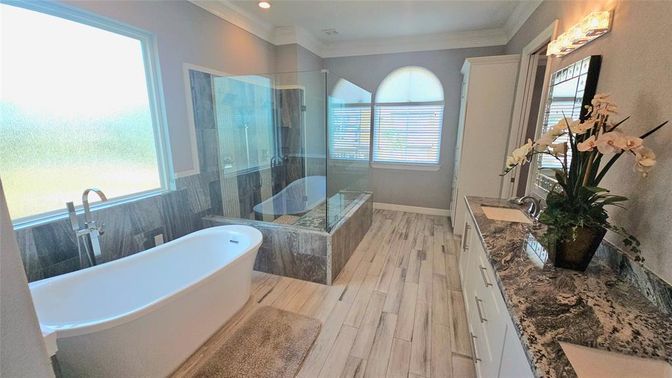 Bathroom, Dual Sink Vanities, Free Standing Baths, Glass Shower, Interior, Recessed Lighting, Wood Texture Flooring