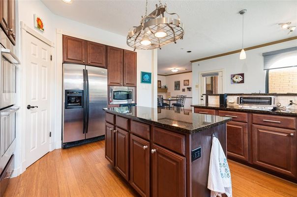 Chandelier, Dining room, Interior, Kitchen, Pendant Lights, Recessed Lighting, Stainless Steel Appliances, Wood Texture Flooring
