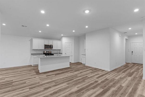 Empty room, Interior, Kitchen, Recessed Lighting, Stainless Steel Appliances, Wood Texture Flooring
