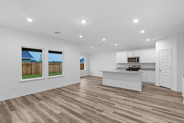Empty room, Interior, Kitchen, Recessed Lighting, Stainless Steel Appliances, Wood Texture Flooring