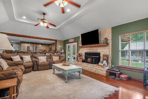 Fireplace, Interior, Kitchen, Living room, Recessed Lighting, Stainless Steel Appliances, Stone Walls, Wood Texture Flooring