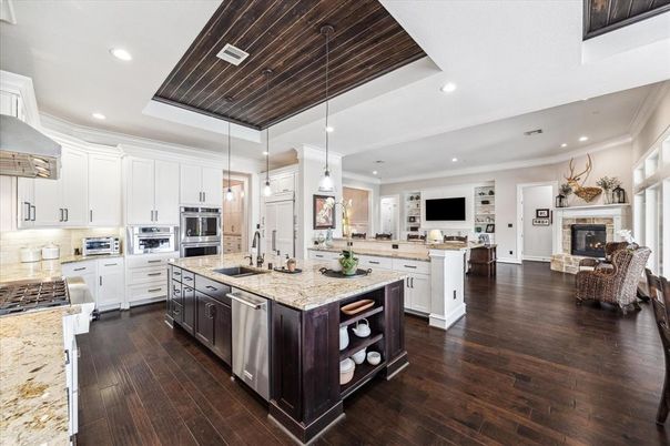 Fireplace, Interior, Kitchen, Living room, Pendant Lights, Recessed Lighting, Stainless Steel Appliances, Wooden Ceilings, Wood Texture Flooring