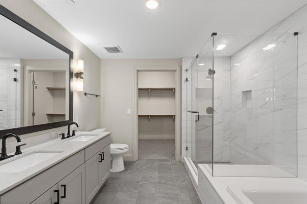 Bathroom, Dual Sink Vanities, Glass Shower, Interior, Marble Walls, Recessed Lighting, Walk-in Closets