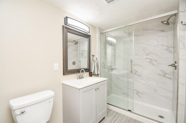 Bathroom, Glass Shower, Interior, Marble Walls, Wood Texture Flooring