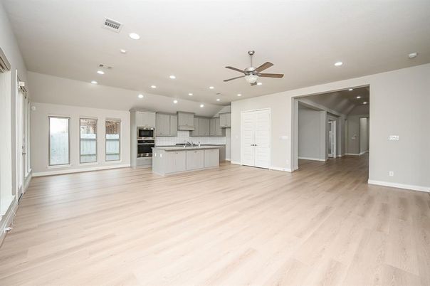 Empty room, Interior, Kitchen, Recessed Lighting, Stainless Steel Appliances, Wood Texture Flooring