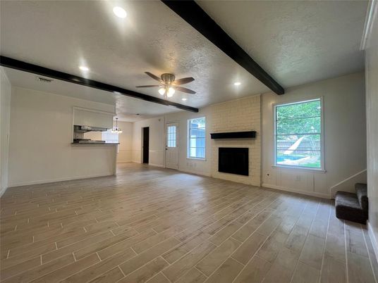 Empty room, Fireplace, Interior, Recessed Lighting, Stone Walls, Wooden Beams, Wood Texture Flooring