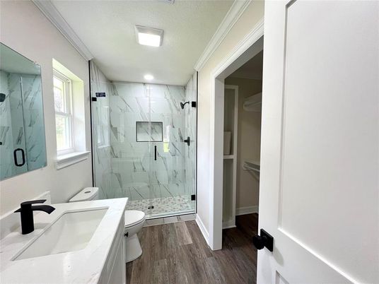 Bathroom, Dual Sink Vanities, Glass Shower, Interior, Marble Walls, Recessed Lighting, Wood Texture Flooring