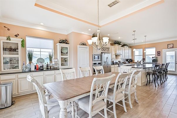 Chandelier, Dining room, Interior, Kitchen, Pendant Lights, Recessed Lighting, Stainless Steel Appliances, Wood Texture Flooring