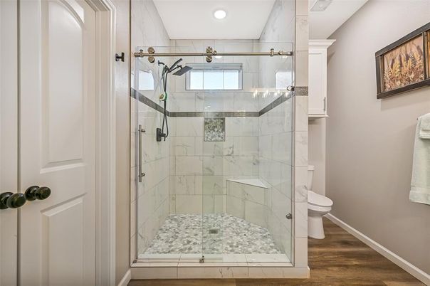 Bathroom, Glass Shower, Interior, Marble Walls, Recessed Lighting, Wood Texture Flooring