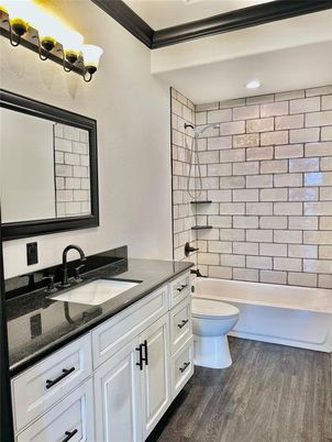 Bathroom, Dual Sink Vanities, Interior, Recessed Lighting, Stone Walls, Wood Texture Flooring