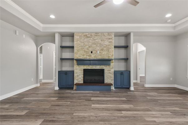 Empty room, Fireplace, Interior, Recessed Lighting, Stone Walls, Wood Texture Flooring
