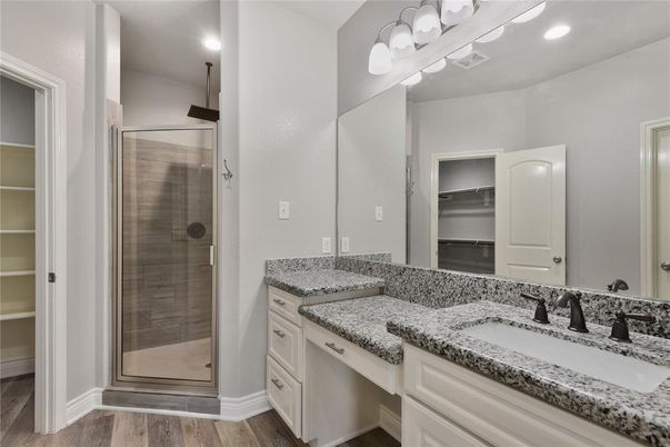 Bathroom, Dual Sink Vanities, Glass Shower, Interior, Recessed Lighting, Wood Texture Flooring
