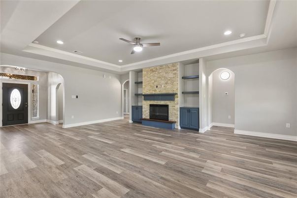 Empty room, Fireplace, Interior, Recessed Lighting, Stone Walls, Wood Texture Flooring