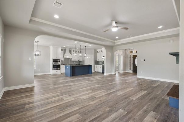 Empty room, Interior, Kitchen, Pendant Lights, Recessed Lighting, Stainless Steel Appliances, Wood Texture Flooring