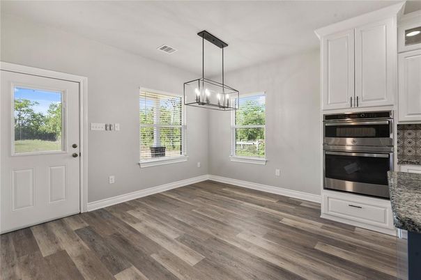 Empty room, Interior, Kitchen, Pendant Lights, Stainless Steel Appliances, Wood Texture Flooring