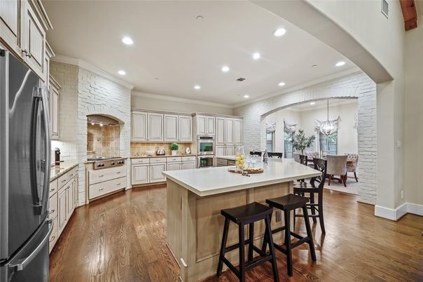 Chandelier, Dining room, Interior, Kitchen, Recessed Lighting, Stainless Steel Appliances, Stone Walls, Wood Texture Flooring