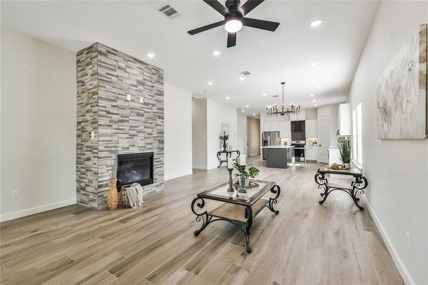 Fireplace, Interior, Kitchen, Pendant Lights, Recessed Lighting, Stainless Steel Appliances, Stone Walls, Wood Texture Flooring