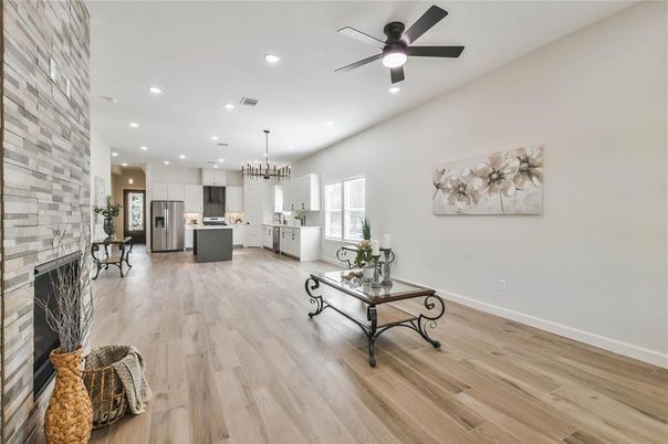 Chandelier, Fireplace, Interior, Kitchen, Pendant Lights, Recessed Lighting, Stainless Steel Appliances, Stone Walls, Wood Texture Flooring