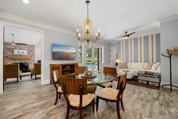 Chandelier, Dining room, Fireplace, Interior, Living room, Recessed Lighting, Stone Walls, Wood Texture Flooring